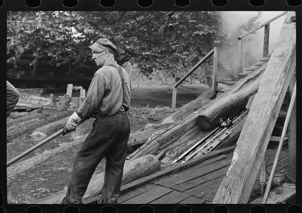 [Untitled photo, possibly related to: Spiking and guiding logs up ramp into mill where they are sawed. Erwin, West…