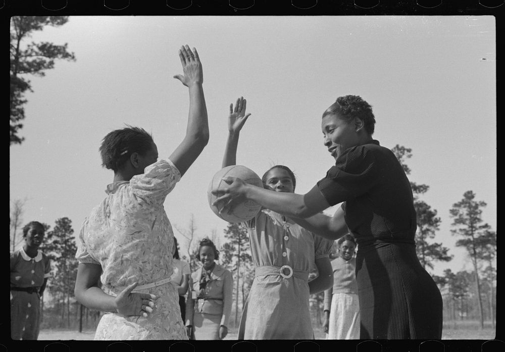 Student with recreational director during basketball game. Prairie Farms, Montgomery, Alabama by Marion Post Wolcott