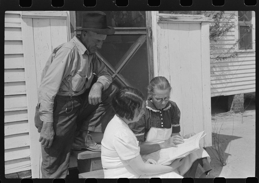 Mr. and Mrs. Watkins, FSA (Farm Security Administration) borrowers, discussing record book with project home economist…
