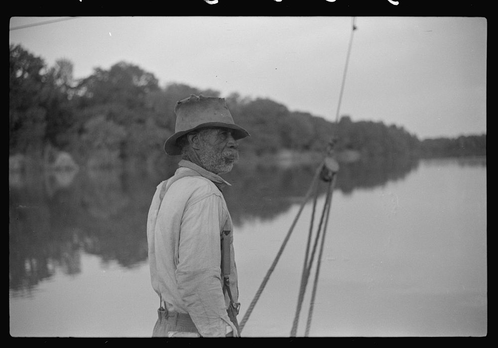 [Untitled photo, possibly related to: Man almost eighty, who has been running ferry across river from Camden to Gee's Bend…
