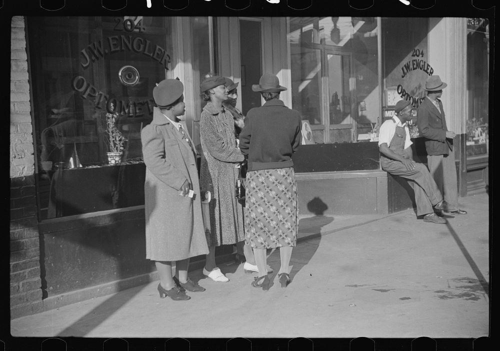 [Untitled photo, possibly related to: Domestic servants waiting for streetcar on way to work early in the morning. Mitchell…
