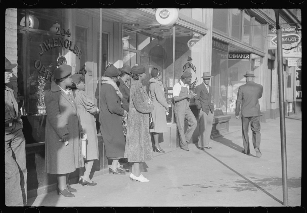 Domestic servants waiting for streetcar on way to work early in the morning. Mitchell Street, Atlanta, Georgia. Sourced from…