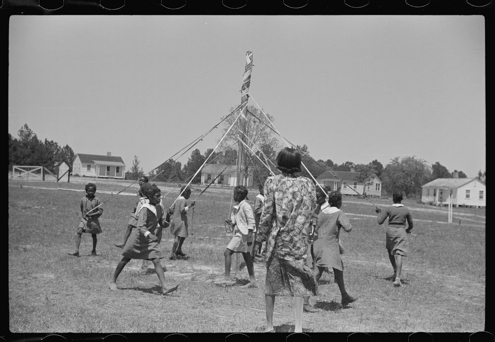 Rehearsing the maypole dance for May Day, health day excercises. Gees Bend, Alabama. Sourced from the Library of Congress.