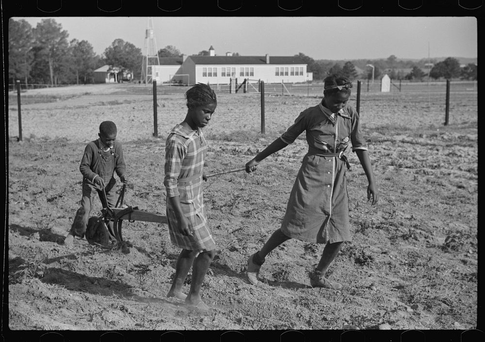Behind the homemade plow in the school garden, Gees Bend, Alabama. Sourced from the Library of Congress.