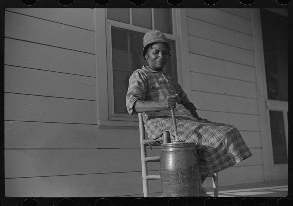Gertrude, churning on Isaiah Pettway's porch, Gees Bend, Alabama. Sourced from the Library of Congress.
