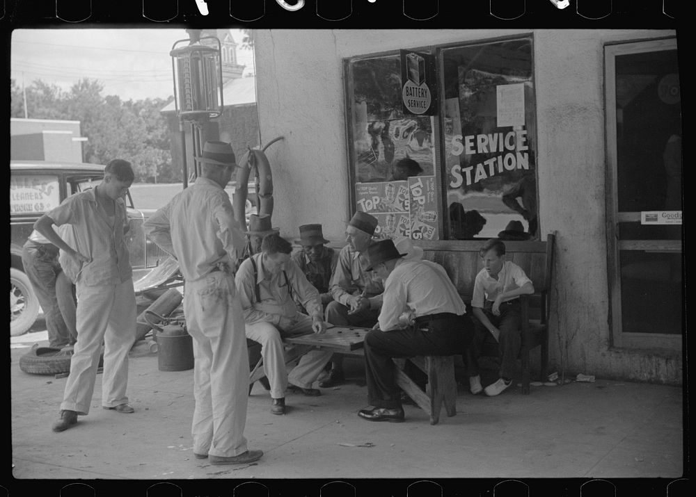 Playing cards outside service station, Saturday afternoon, Greensboro, Greene County, Georgia. Sourced from the Library of…