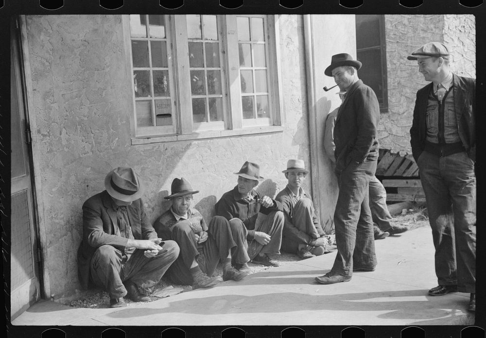 [Untitled photo, possibly related to: Migratory packinghouse workers waiting around post office during slack season. Belle…