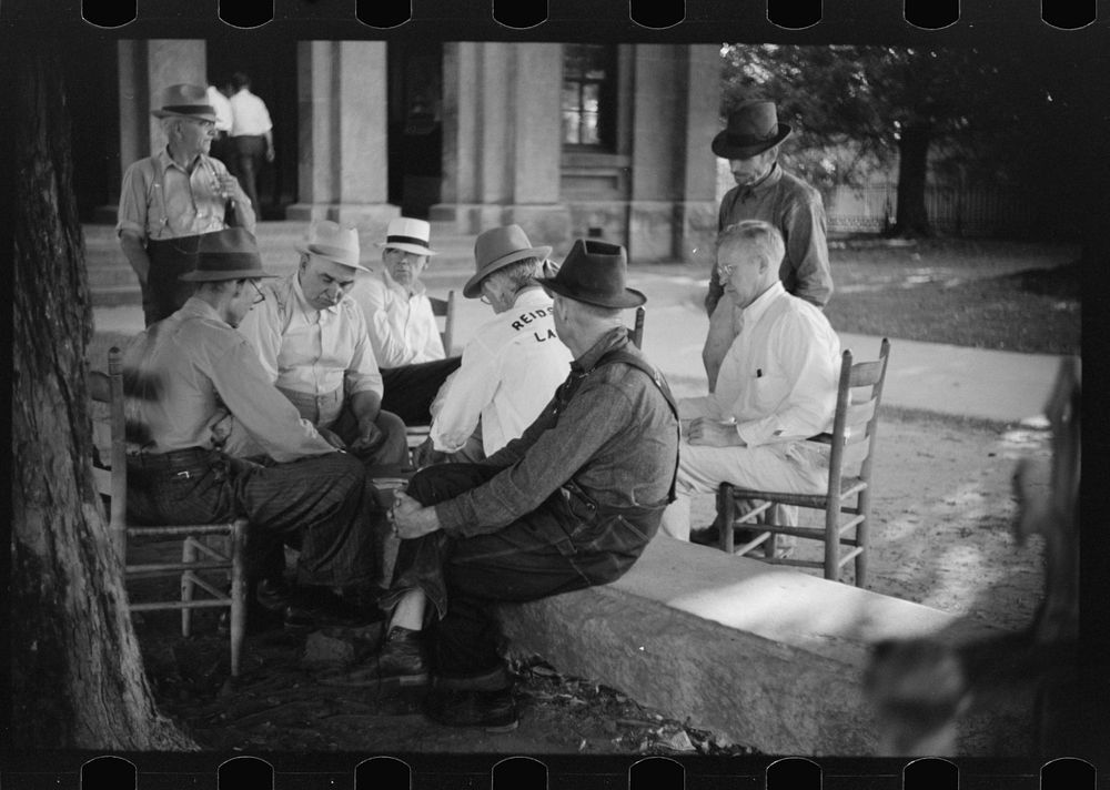 Townspeople and farmers playing cards in front of courthouse on Saturday afternoon in Yanceyville, Caswell County, North…