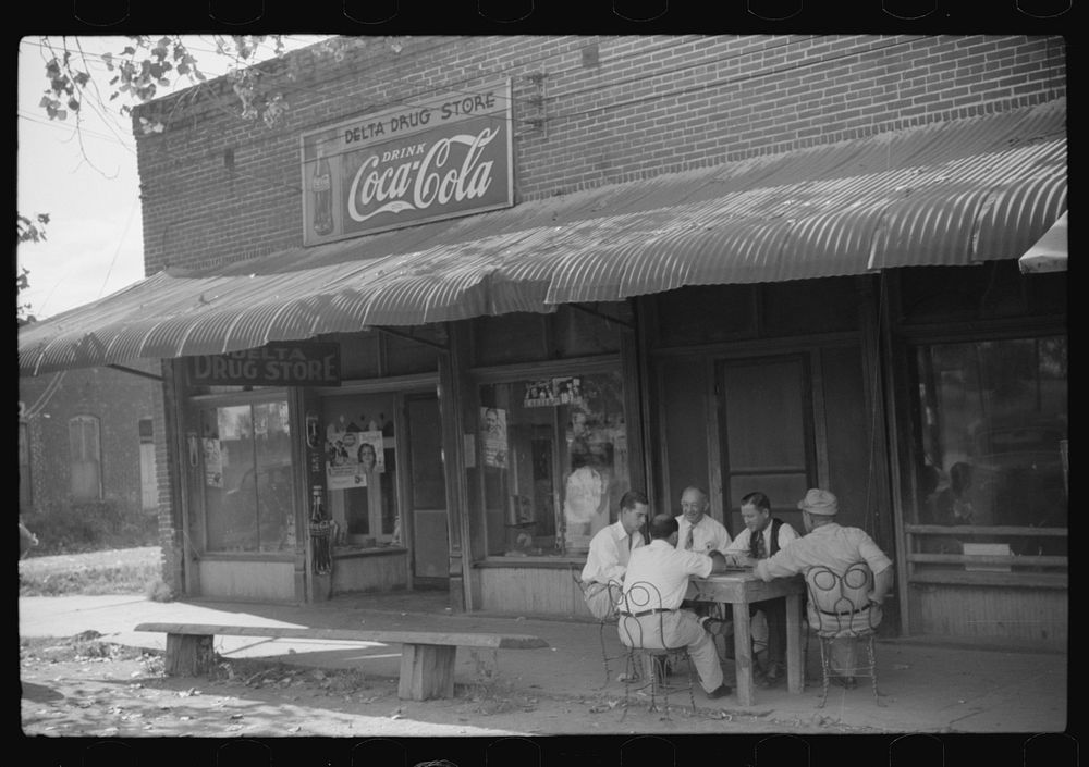 [Untitled photo, possibly related to: Playing dominoes or cards in front of drug store in center of town, in Mississippi…