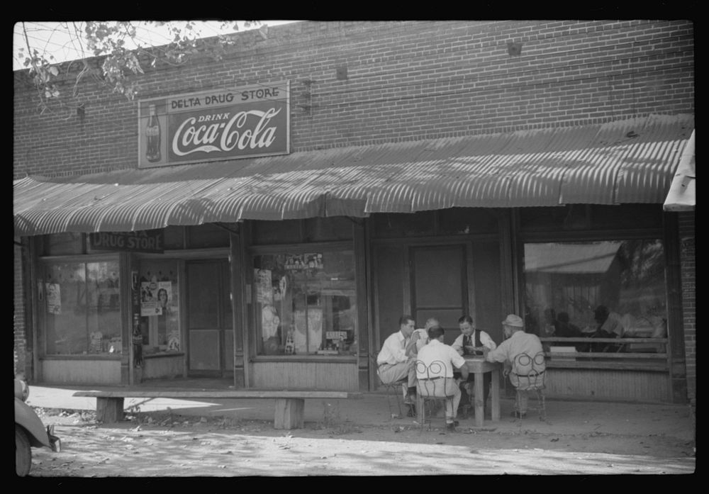 [Untitled photo, possibly related to: Playing dominoes or cards in front of drug store in center of town, in Mississippi…