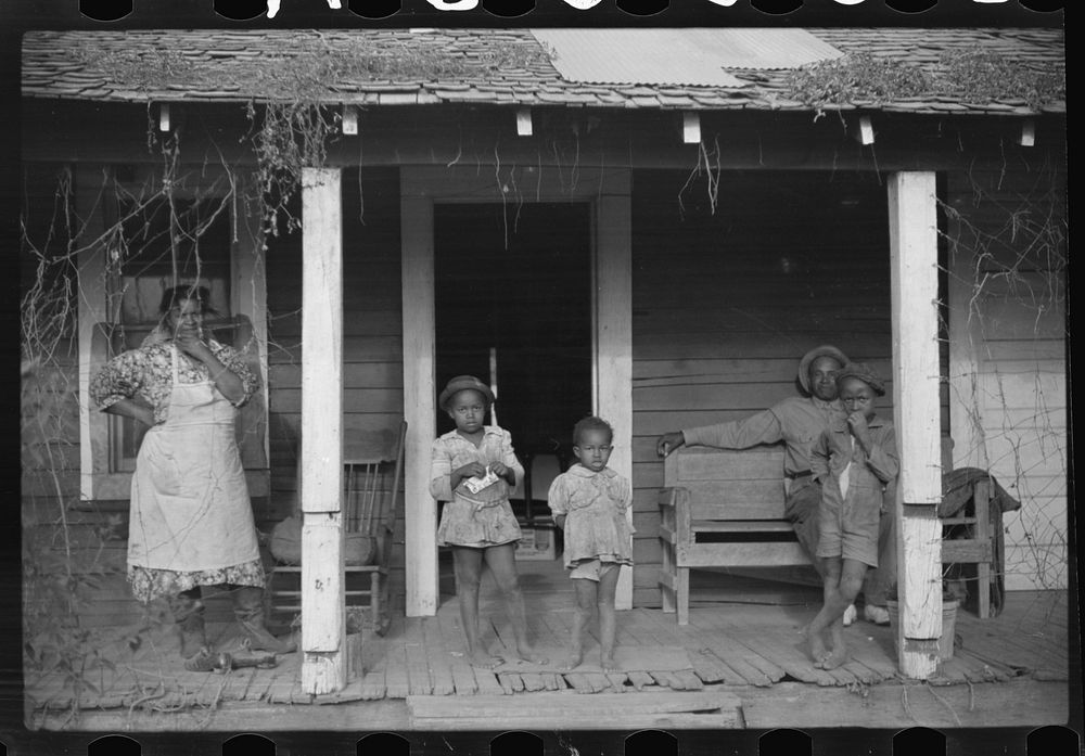 [Untitled photo, possibly related to: One of tenant families on their porch, Marcella Plantation, Mileston, Mississippi…