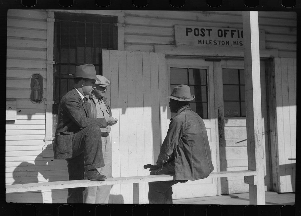 Mr. Jones, one of the owners of Marcella Plantation, with manager of Goodhope Plantation talking to one of  tenants on porch…