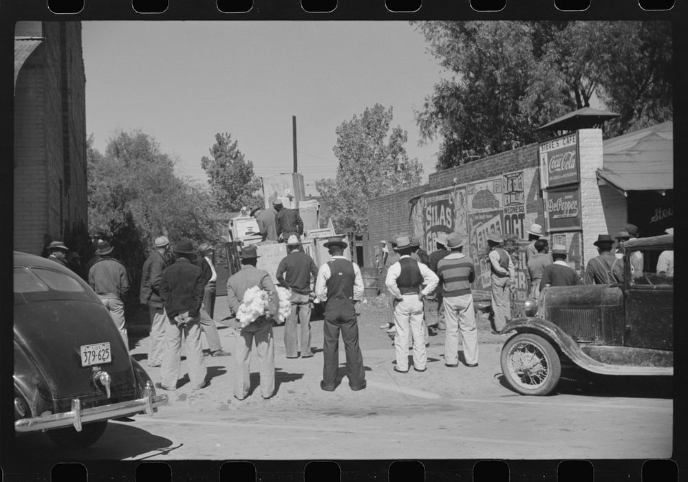 [Untitled photo, possibly related to: Some of the es watching itinerant salesman selling goods from his truck in center of…