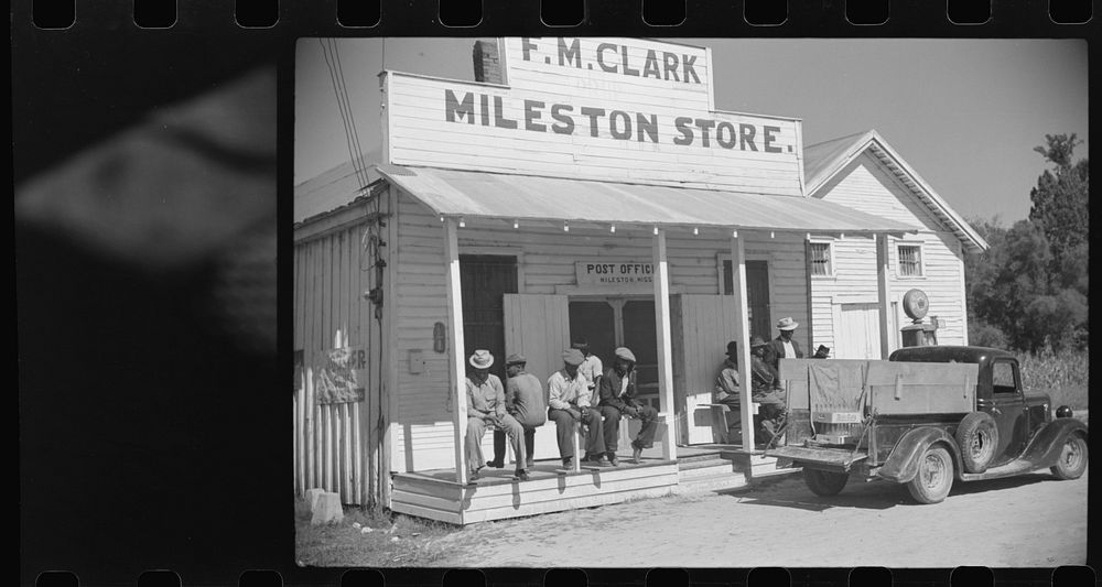 [Untitled photo, possibly related to: Tenants on porch of cotton plantation store, Mileston, Mississippi Delta…