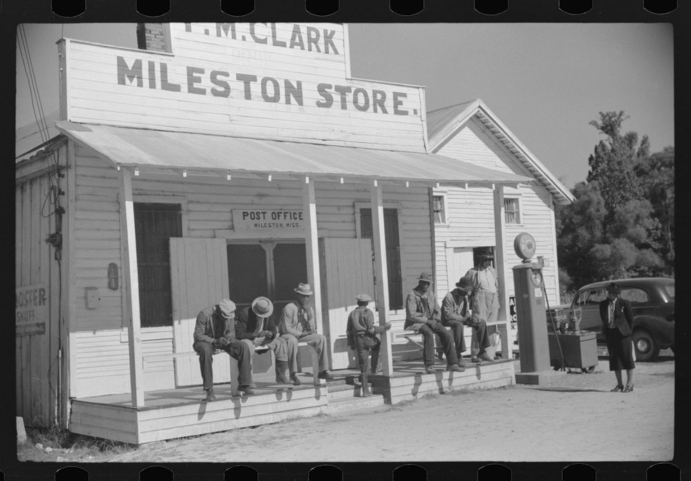 [Untitled photo, possibly related to: Tenants on porch of cotton plantation store, Mileston, Mississippi Delta…