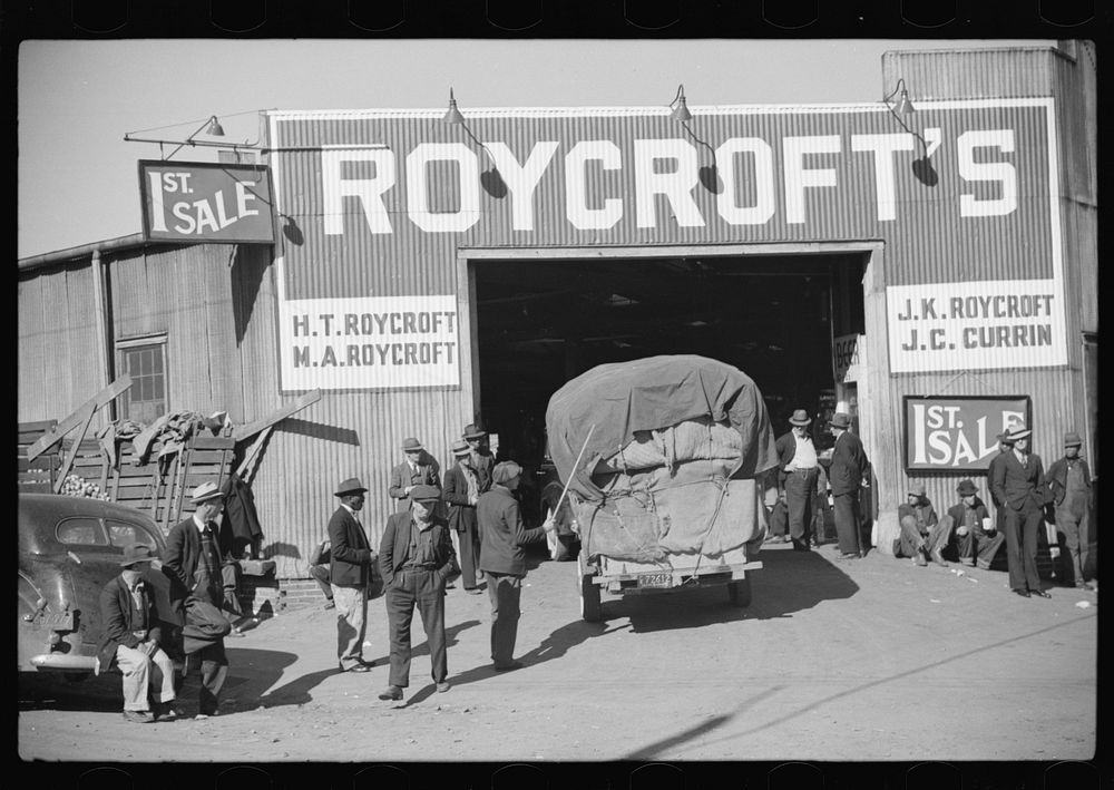 Tobacco being brought into warehouse on trailer for auction sale. Durham, North Carolina. Sourced from the Library of…