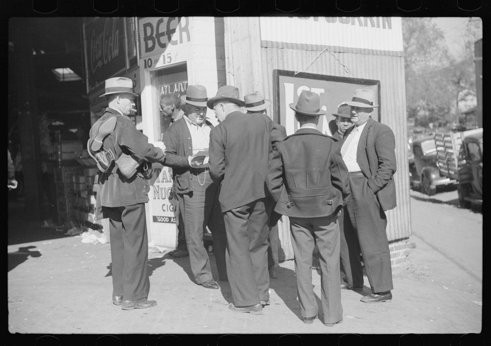 Selling shoes to farmers outside warehouse during tobacco auction, Durham, North Carolina. Sourced from the Library of…
