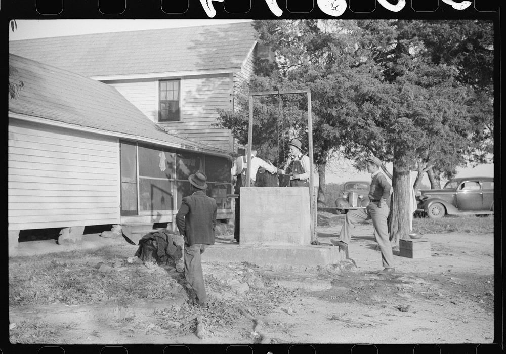 Men drinking from well on farm near the Fred Wilkins place. They have been shucking corn. Granville County, North Carolina.…