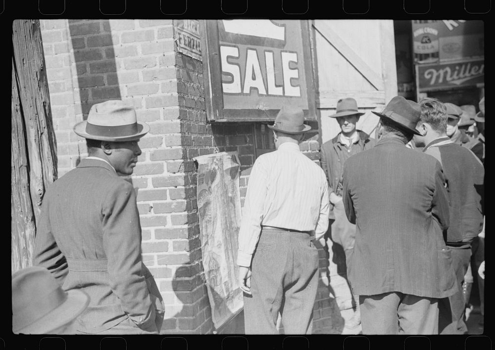 [Untitled photo, possibly related to: Patent medicine salesman talking to farmers outside warehouse during tobacco auction…