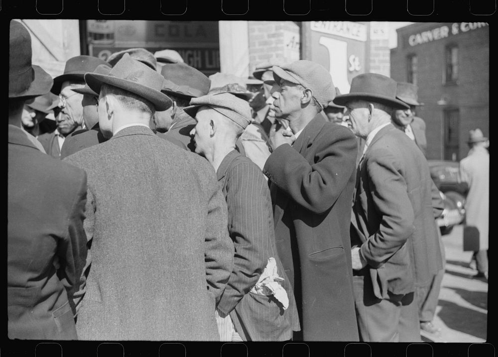 [Untitled photo, possibly related to: Patent medicine salesman talking to farmers outside warehouse during tobacco auction…