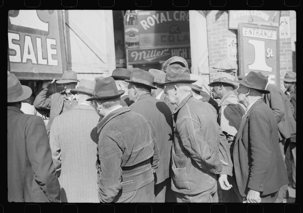 [Untitled photo, possibly related to: Spectators listening to patent medicine salesman who has his stand outside tobacco…