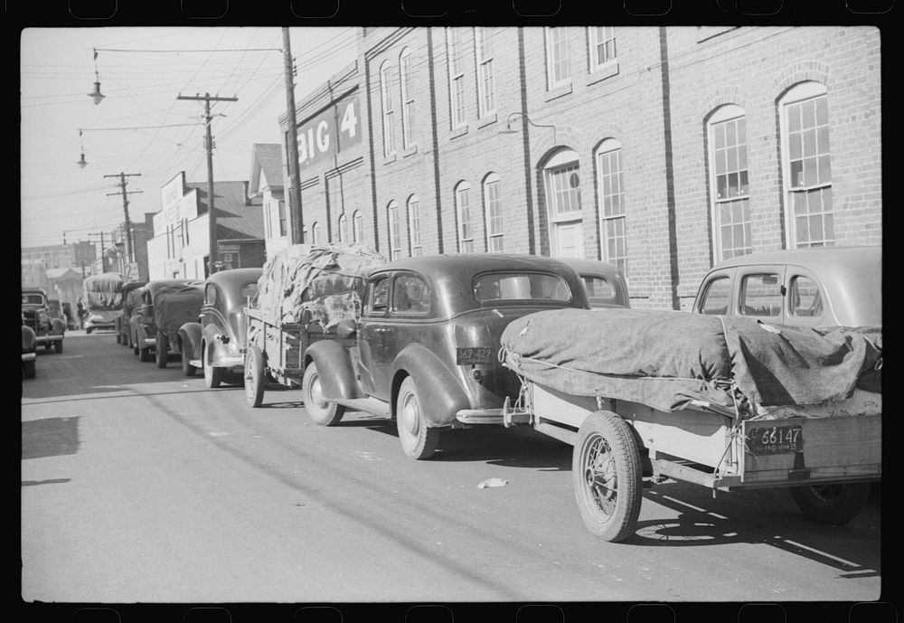 [Untitled photo, possibly related to: Farmers bringing tobacco to warehouse in trailers, on top of their cars and even…