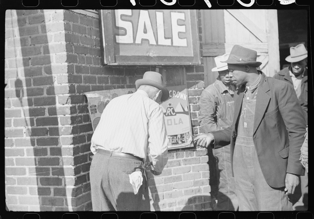 [Untitled photo, possibly related to: Patent medicine salesman demonstrating his wares to farmers outside warehouse during…