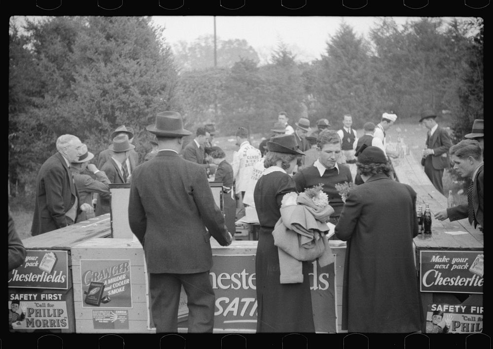 Spectators at refreshment stand during the halves of the Duke University-North Carolina football game. Durham, North…