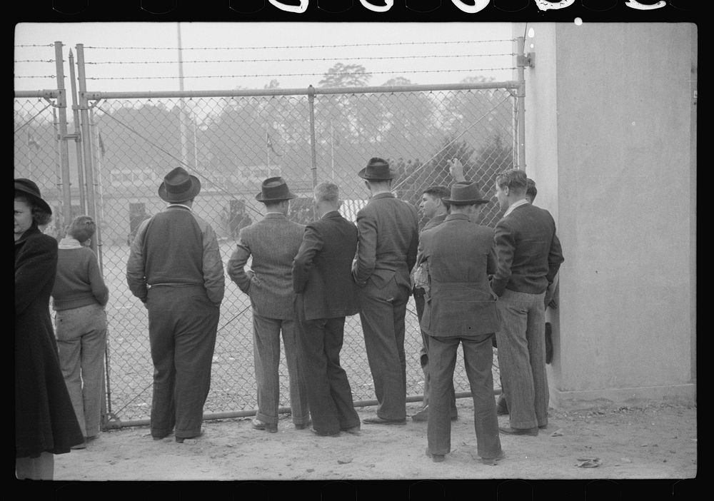 [Untitled photo, possibly related to: Spectators standing outside the gate of the Duke University Stadium because there were…