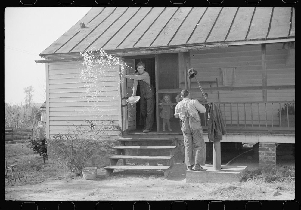 Men who were helping with corn shucking going into house to wash up before dinner. Fred Wilkins farm. Tally Ho, near Stem…