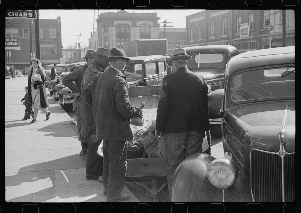 [Untitled photo, possibly related to: Farmers waiting around outside warehouse before tobacco auction sale.  Tobacco was…