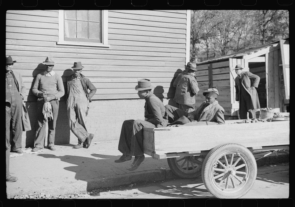 [Untitled photo, possibly related to: Farmers waiting around outside warehouse for tobacco auction sale to begin. Tobacco…