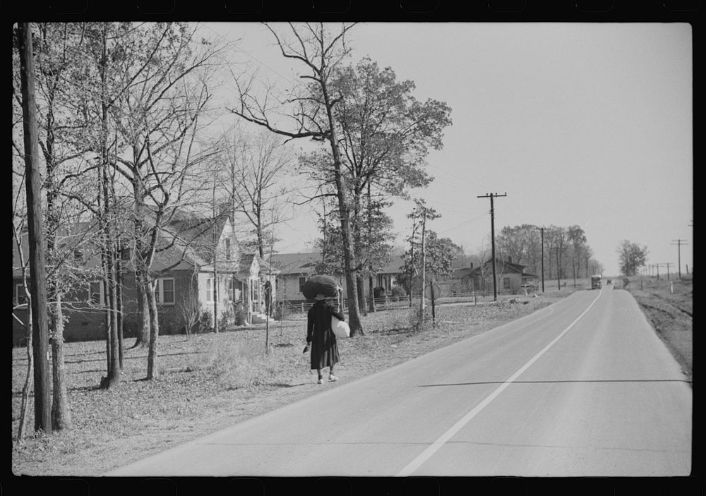 [Untitled photo, possibly related to:  woman carrying laundry home along highway between Durham and Mebane, North Carolina].…