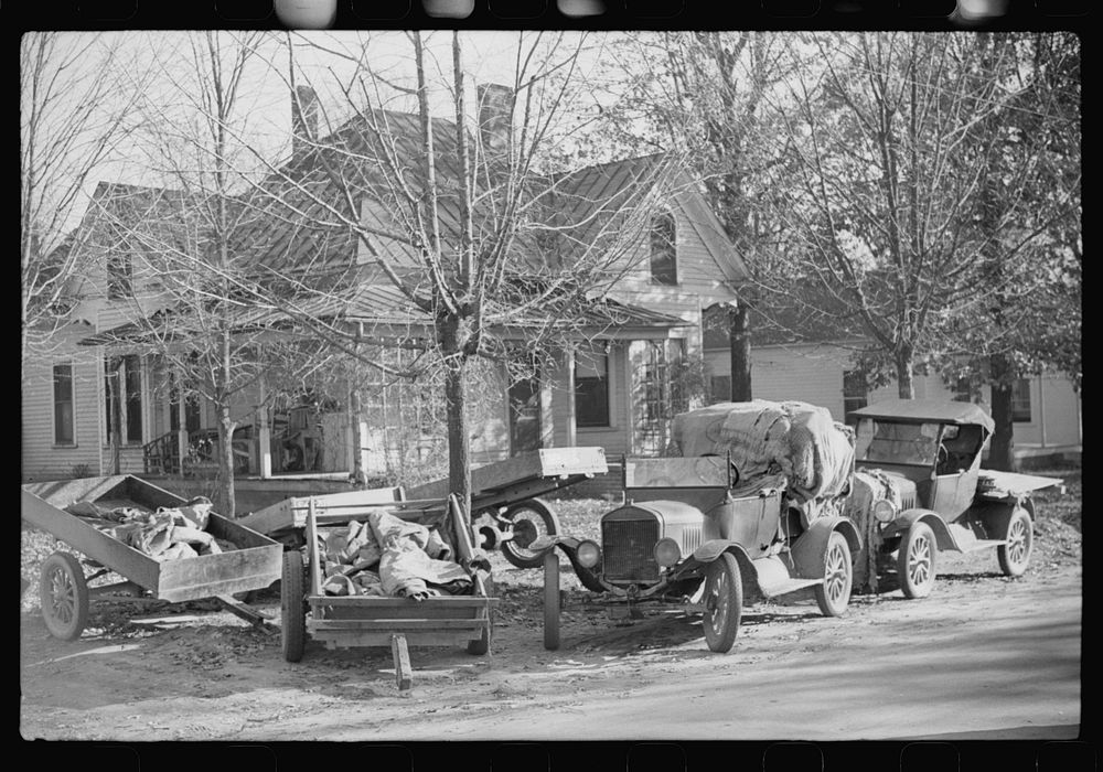 [Untitled photo, possibly related to: Trailers and cars belonging to farmers. They bring their tobacco for auction in all…