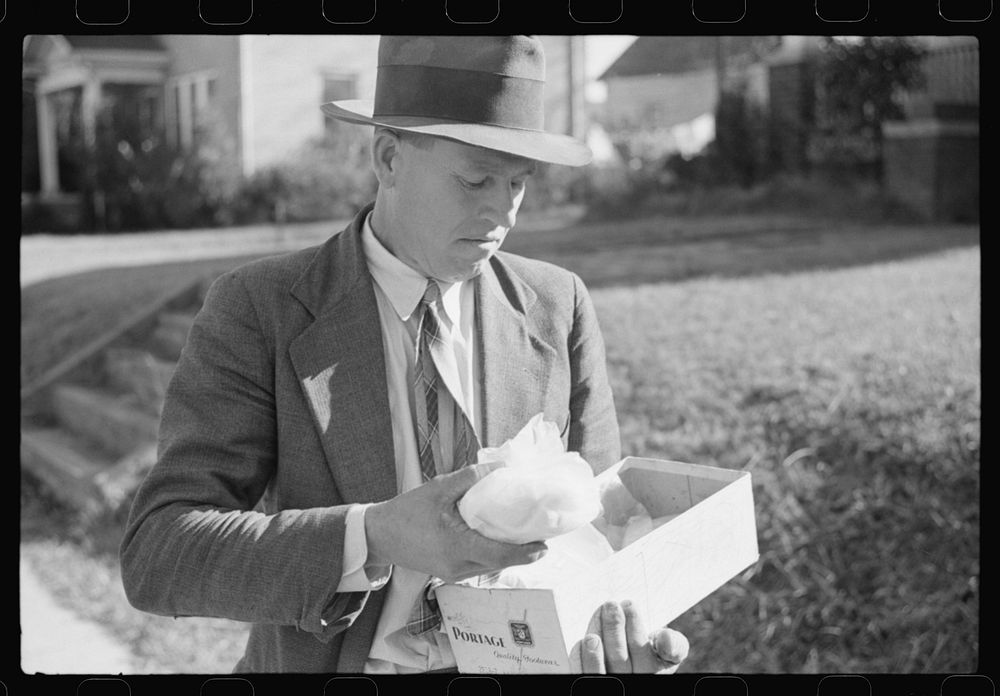 Mr. Evan Wilkins with butter he is selling which was made on his farm.  Durham, North Carolina. Sourced from the Library of…