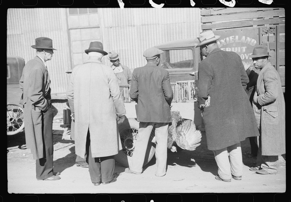 [Untitled photo, possibly related to: Farmer selling Thanksgiving turkey to farmer outside warehouse where tobacco auction…