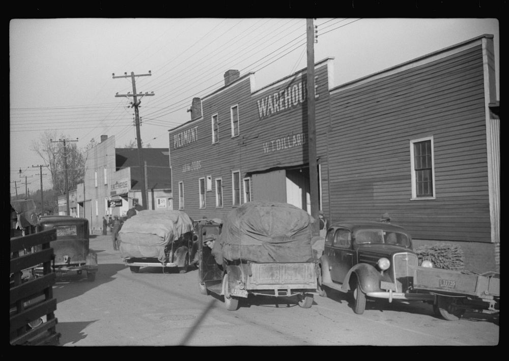 [Untitled photo, possibly related to: Trailers and cars belonging to farmers. They bring their tobacco for auction in all…