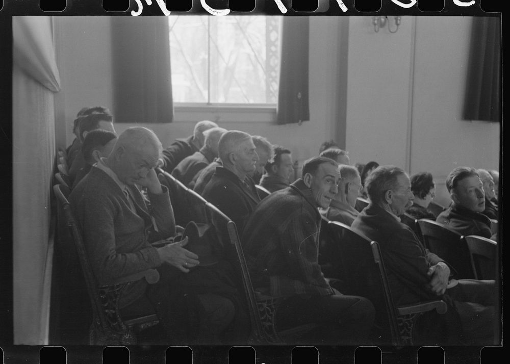 Townspeople listening to discussion during meeting, Woodstock, Vermont. Sourced from the Library of Congress.