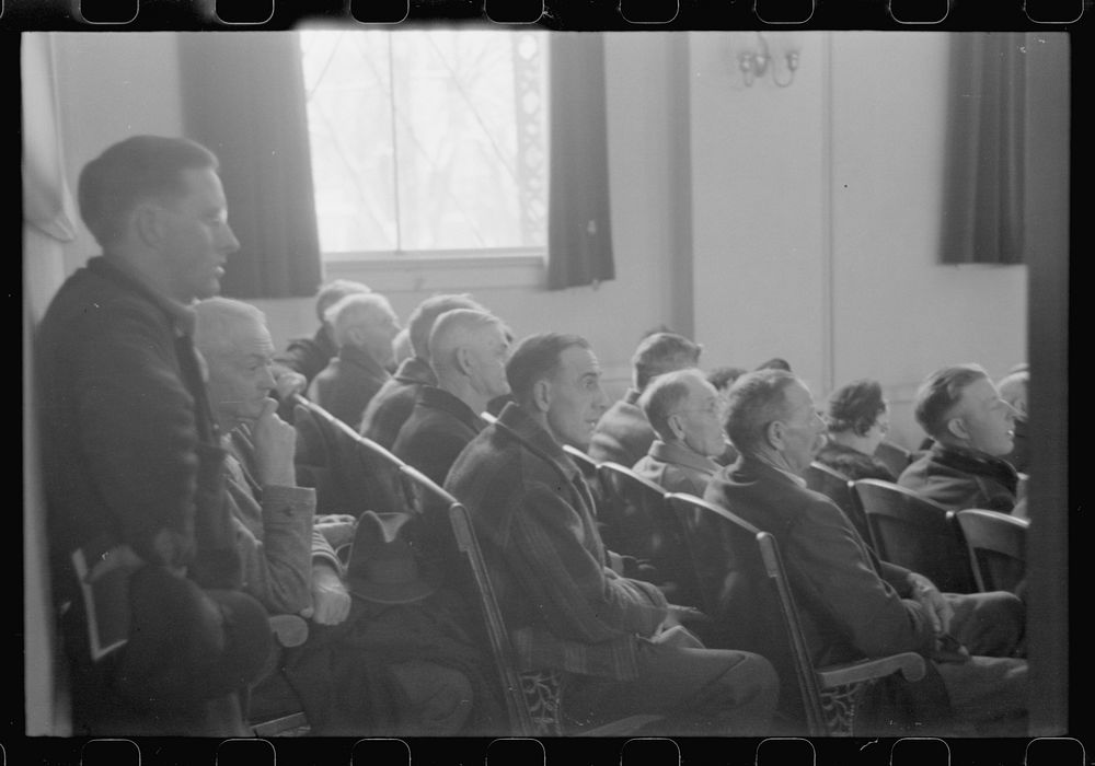 [Untitled photo, possibly related to: Townspeople listening to discussion during meeting, Woodstock, Vermont]. Sourced from…