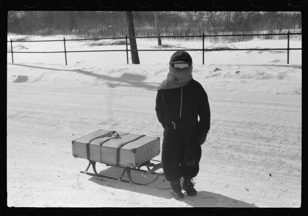 Child bringing home suitcase on sled, Franconia, New Hampshire. Sourced from the Library of Congress.