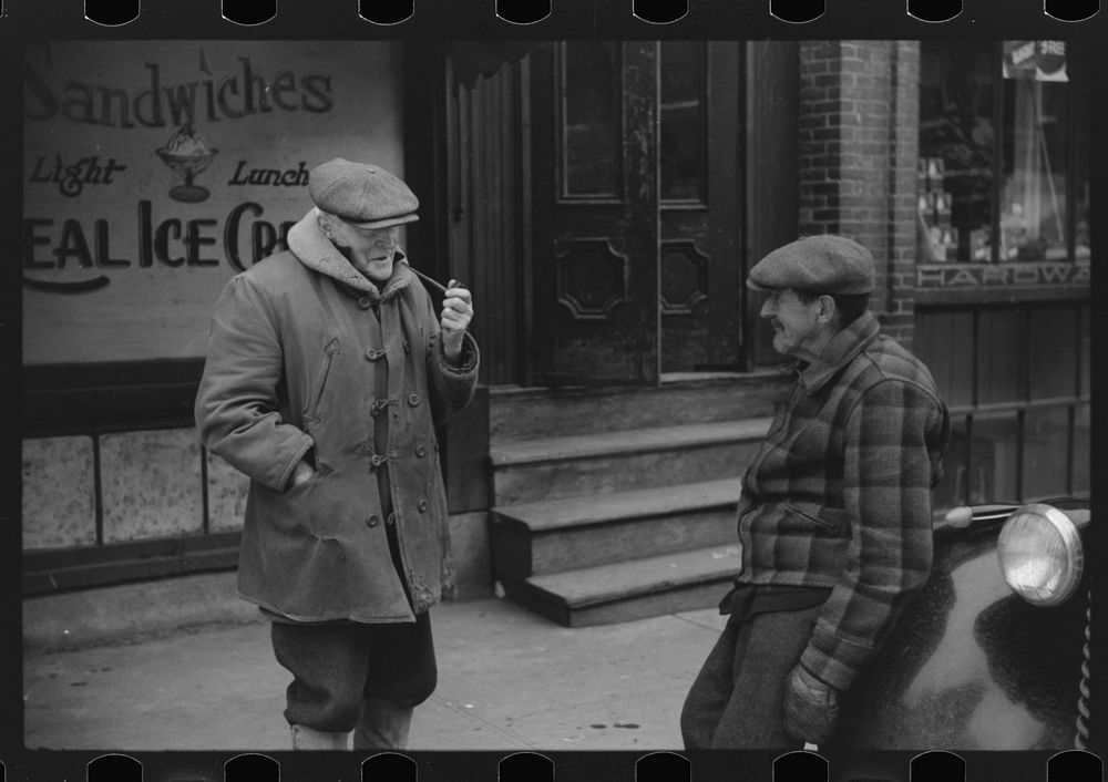 Townspeople of Woodstock, Vermont discussing the severe winter on the street corner in center of town. Sourced from the…