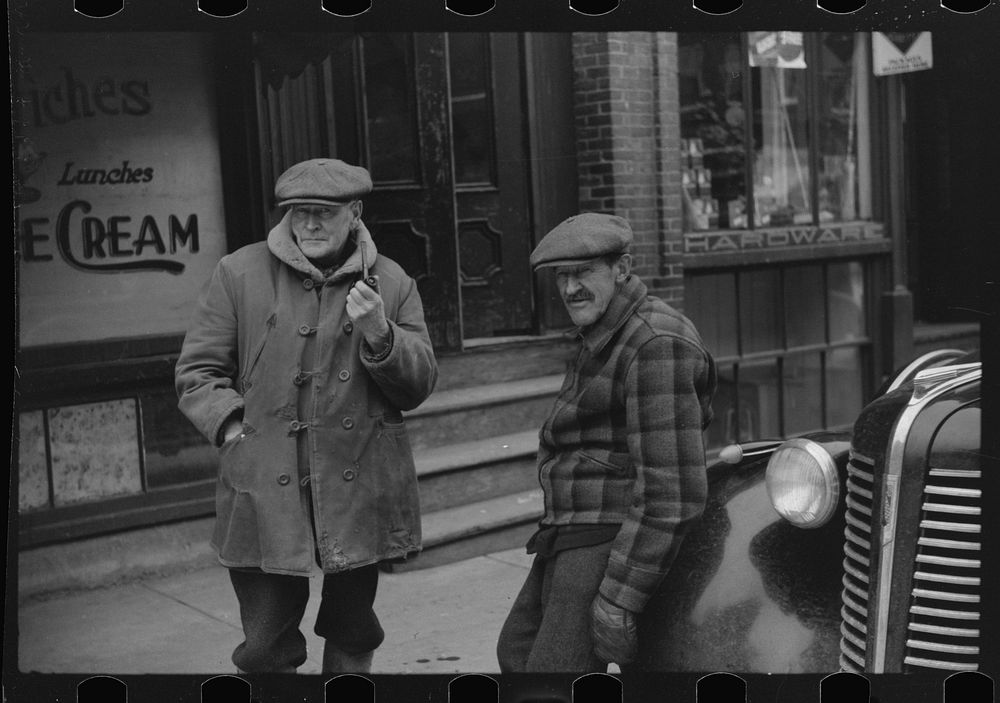 [Untitled photo, possibly related to: Townspeople of Woodstock, Vermont discussing the severe winter on the street corner in…