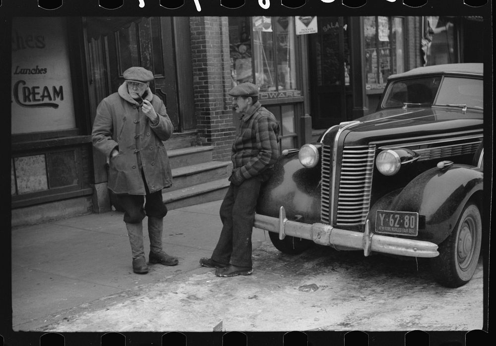 [Untitled photo, possibly related to: Townspeople of Woodstock, Vermont discussing the severe winter on the street corner in…