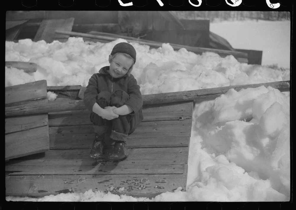 Young daughter of Frank H. Shurtleff sitting outside sugar house where sap from maple trees is boiled down into maple syrup.…