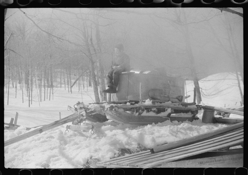 [Untitled photo, possibly related to: Mr. Shurtleff's child sitting on top of vat and sled in which sap for maple syrup is…