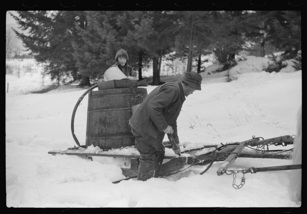 [Untitled photo, possibly related to: Walter Gaylord and son on sled with vat full of sap from sugar maple trees which is…