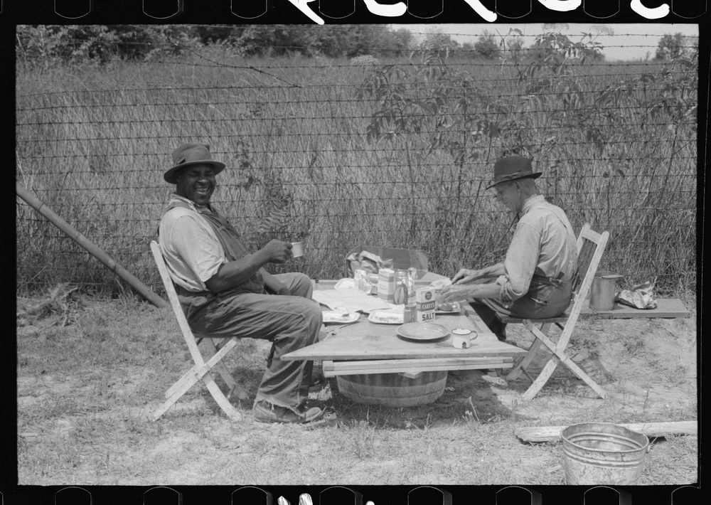 Stable hand and trainer eating picnic lunch before the Shelby County Horse Show and Fair, Shelbyville, Kentucky. Sourced…