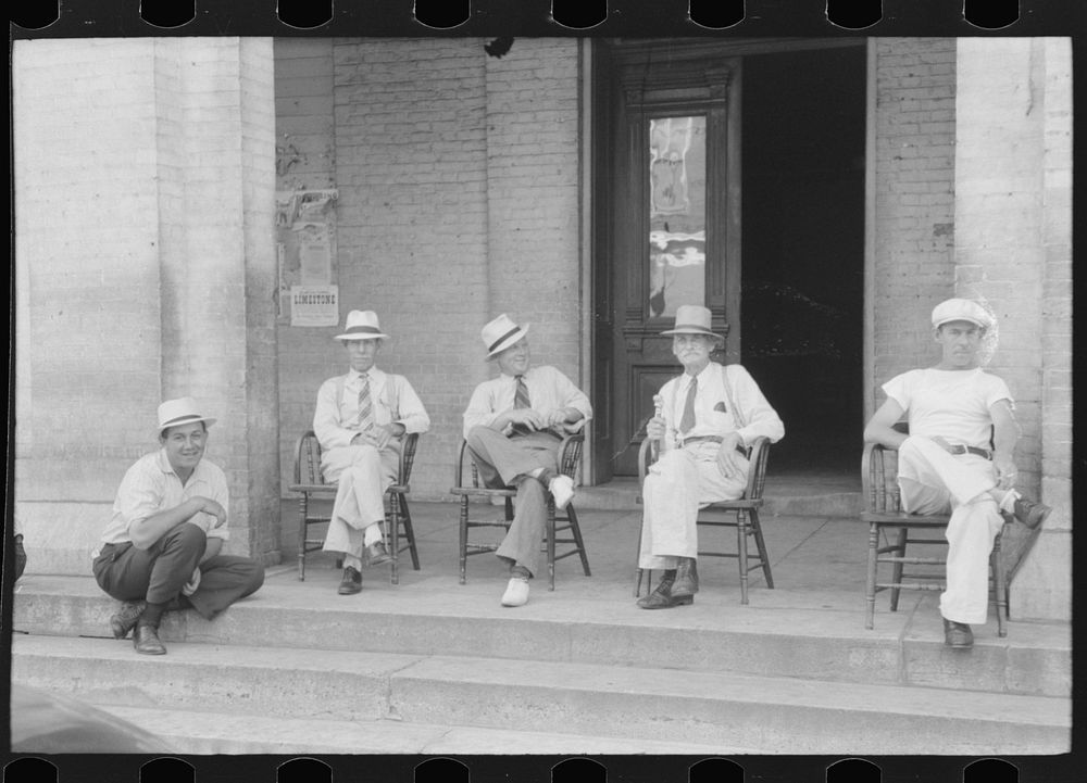 [Untitled photo, possibly related to: Farmers exchange news and greetings in front of courthouse on Saturday afternoon.…