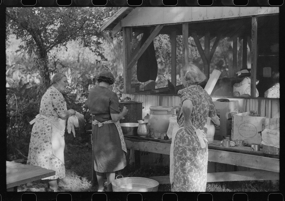 Parishoners preparing food for a benefit picnic supper on the grounds of St. Thomas Church. Near Bardstown, Kentucky.…