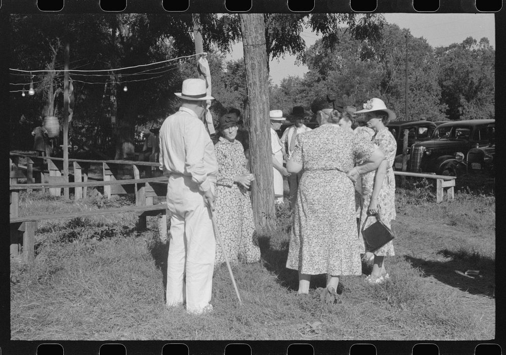 [Untitled photo, possibly related to: Parishoners gossiping while waiting for picnic supper at St. Thomas Church Picnic near…